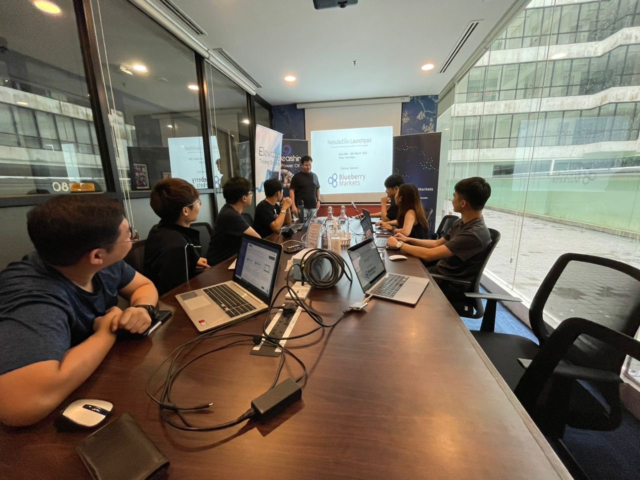 Team discussion in a boardroom with trading presentation