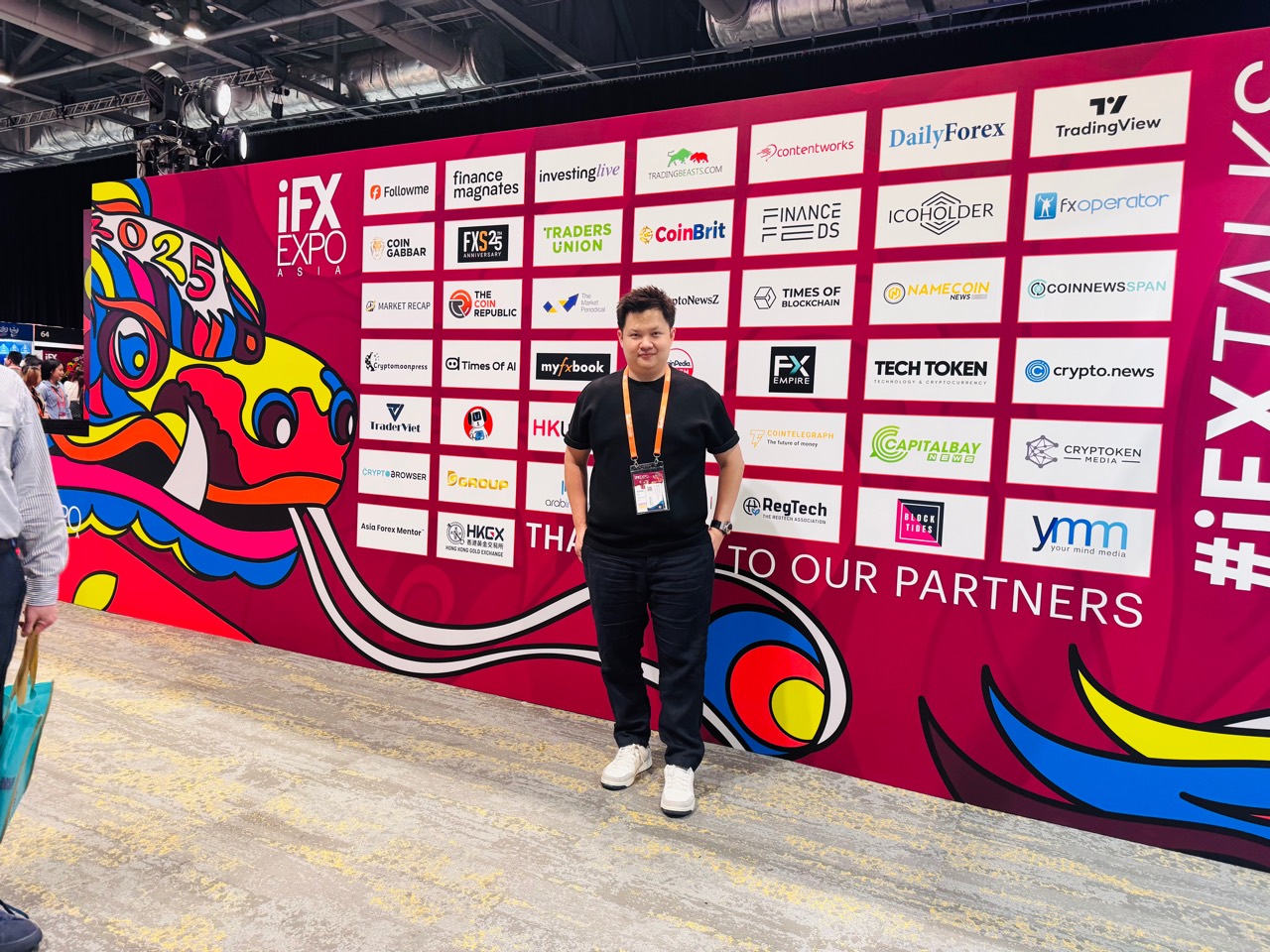 Lucas Loo at iFX Expo Asia partner wall