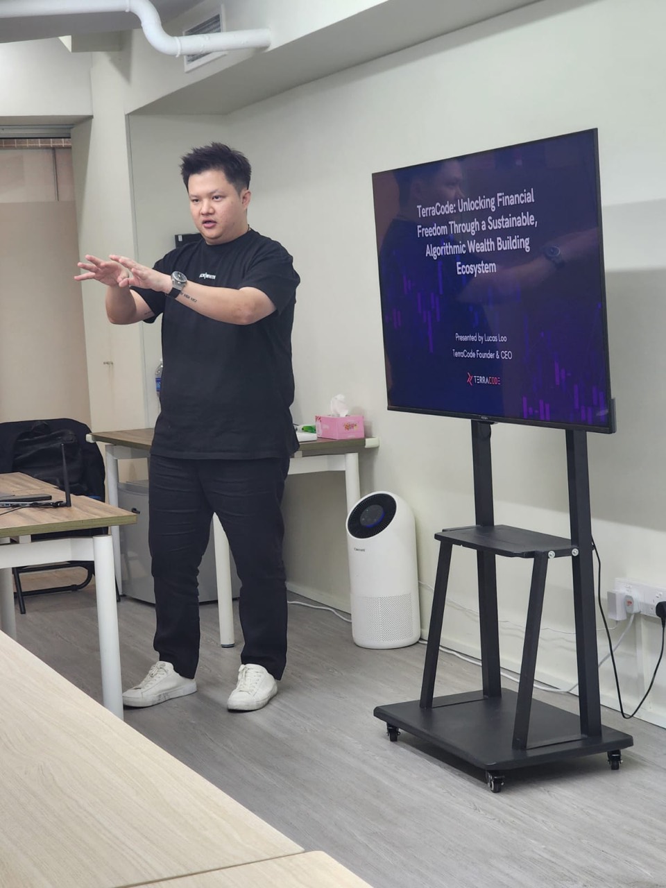 Lucas Loo presenting beside a TerraCode screen